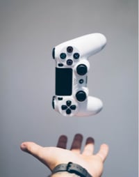 image of gamepad falling on hand